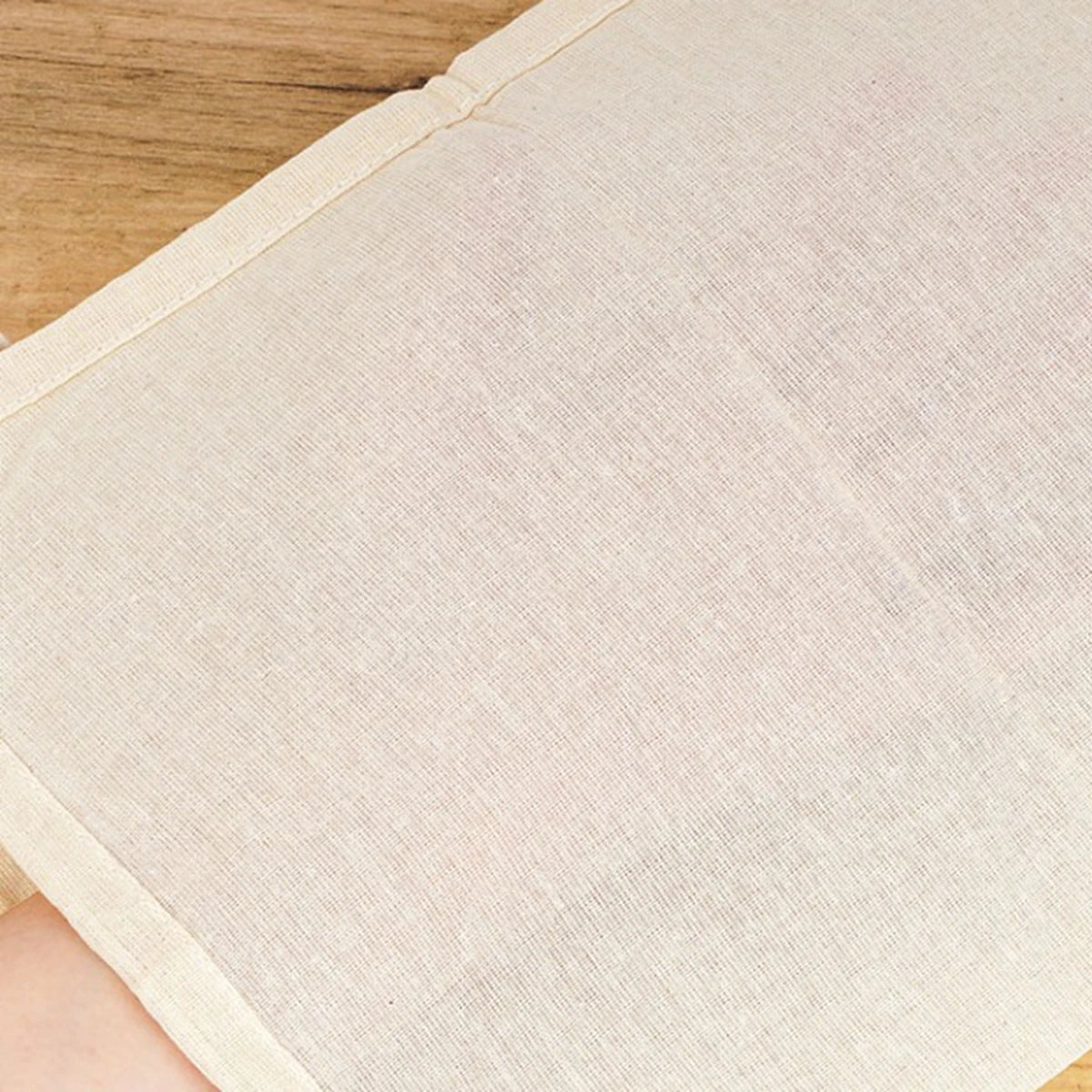 Close-up view of organic unbleached cheesecloth, showcasing its fine weave and natural fibers